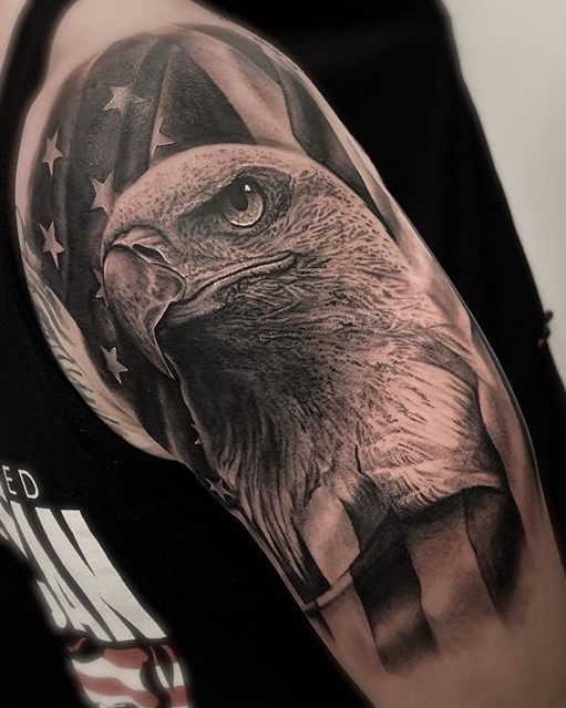 American Flag with Bald Eagle head tattoo. Extremely detailed realistic black and grey shoulder partial sleeve tattoo. Book a custom tattoo with Alan at Sacred Mandala Studio - Durham, NC.